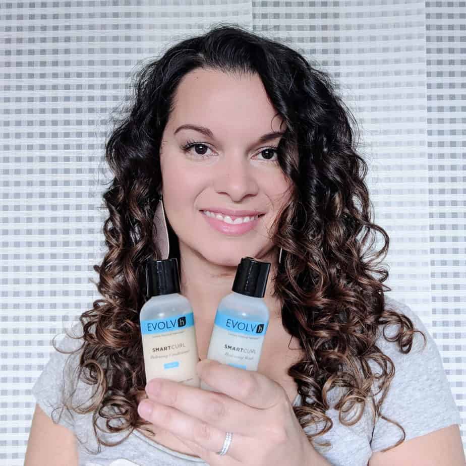 Delilah Orpi holding EVOLVh SmartCurl products for  2B 2C 3A hair