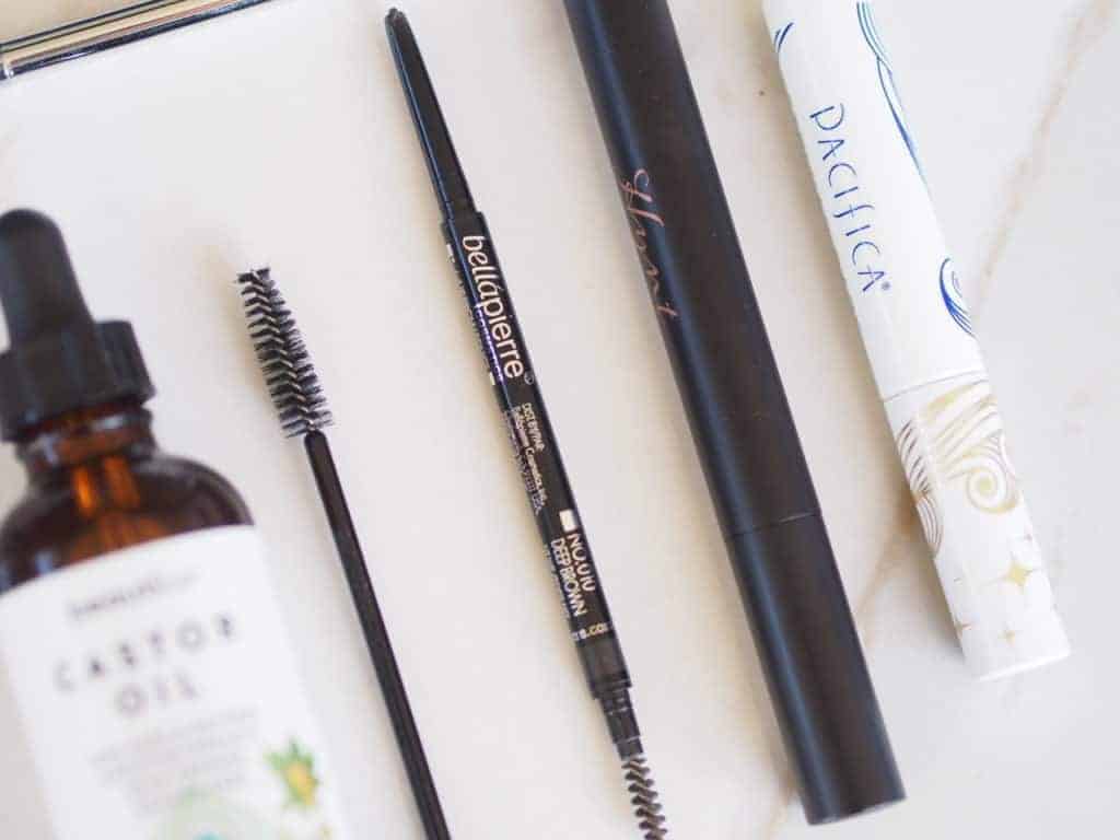 Delilah's favorite natural mascara and brow products on counter  BellaPierre TwistUp brow pencil Pacifica liner and castor oil 