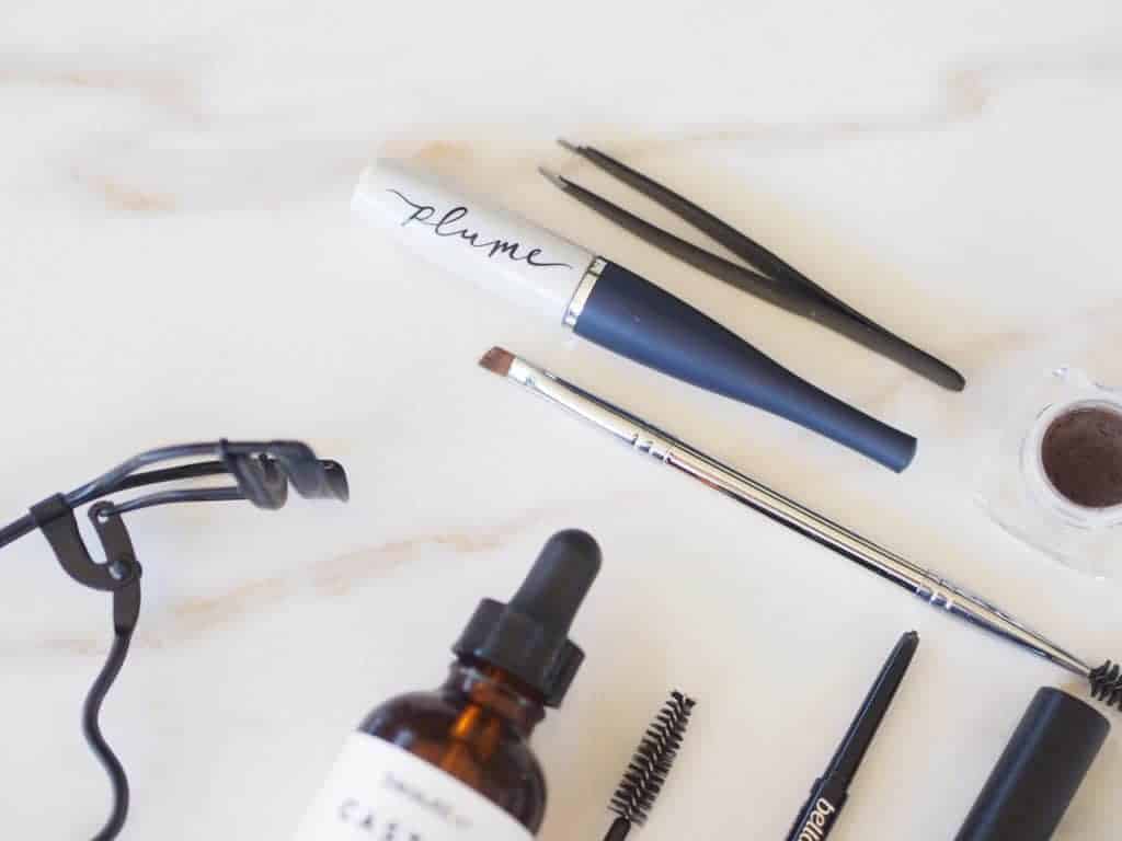 Some of Delilah's favorite natural brow growth serum products on counter