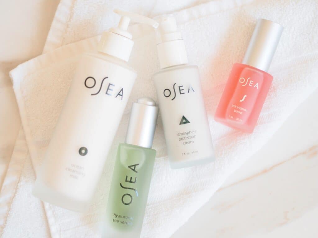 Osea products for glowing summer skin on a white cloth on a table