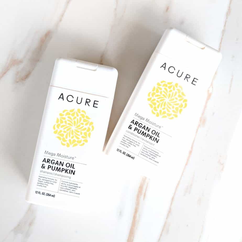 curly girl method products shampoo and conditioner Acure brand on marble counter