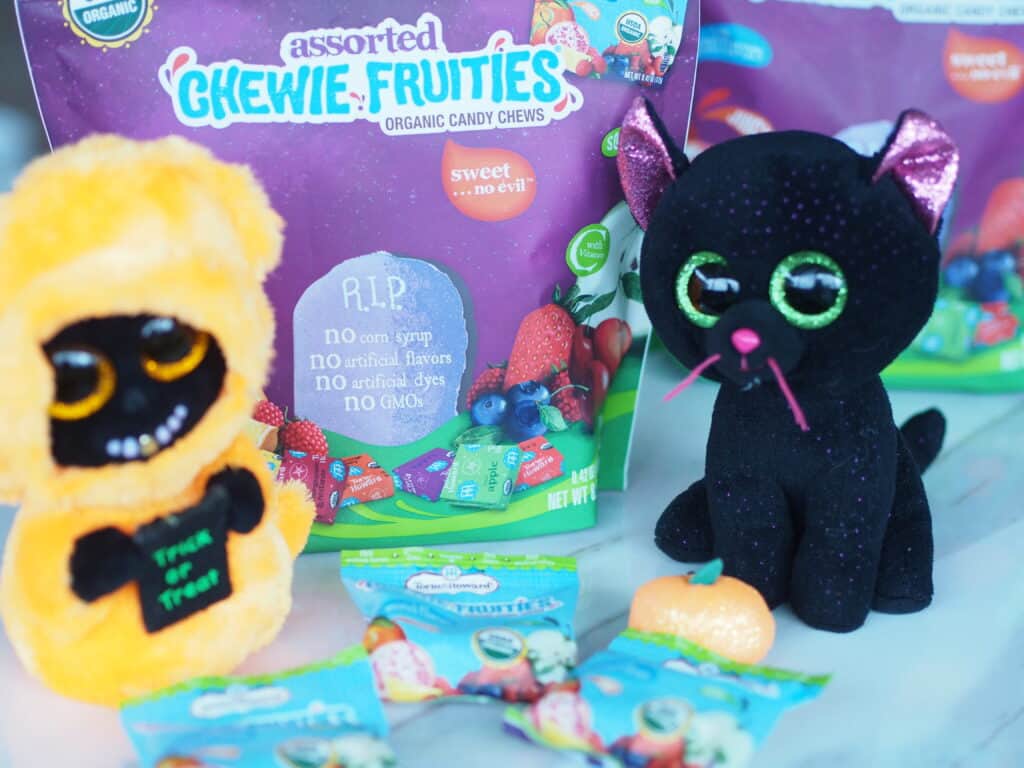 vegan candy shown with two Halloween stuffed animals