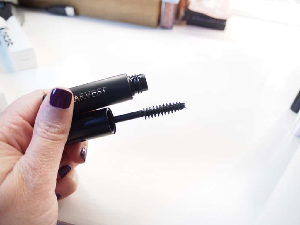 woman holding Harvest Natural Beauty mascara in her hand