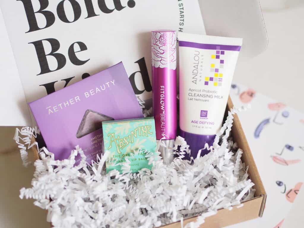 Clean green beauty samples shown in box with packing ribbon on table