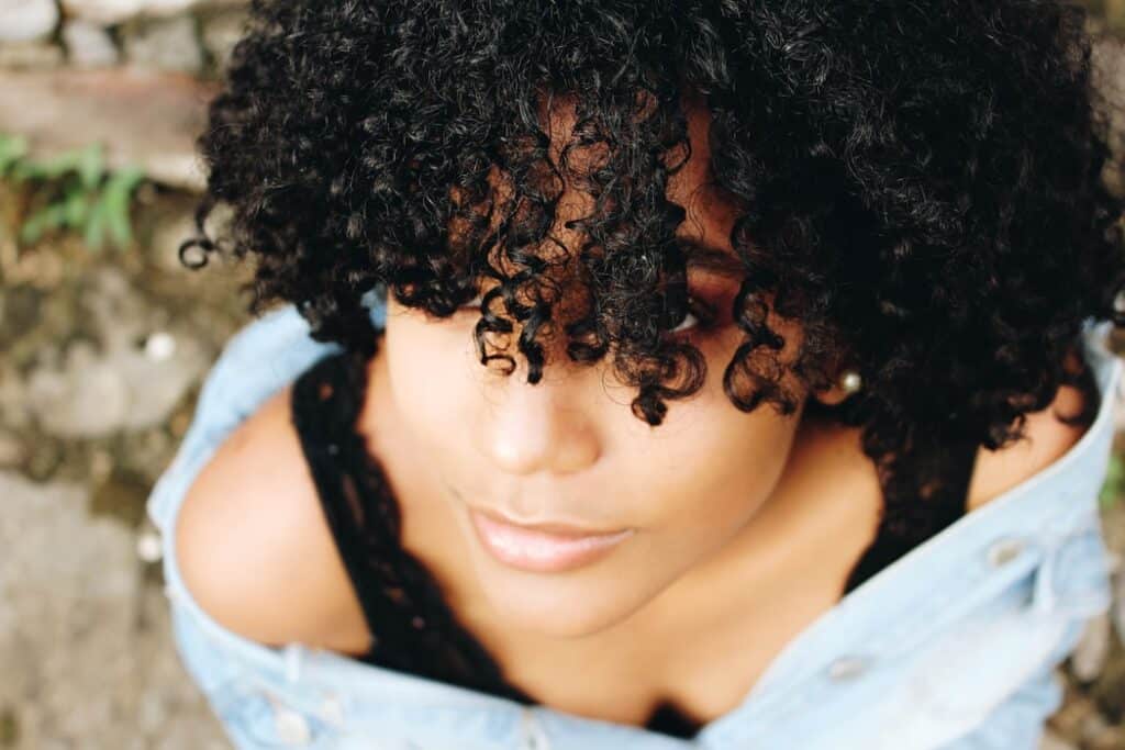 woman with curly hair looking up -used Cantu hair products