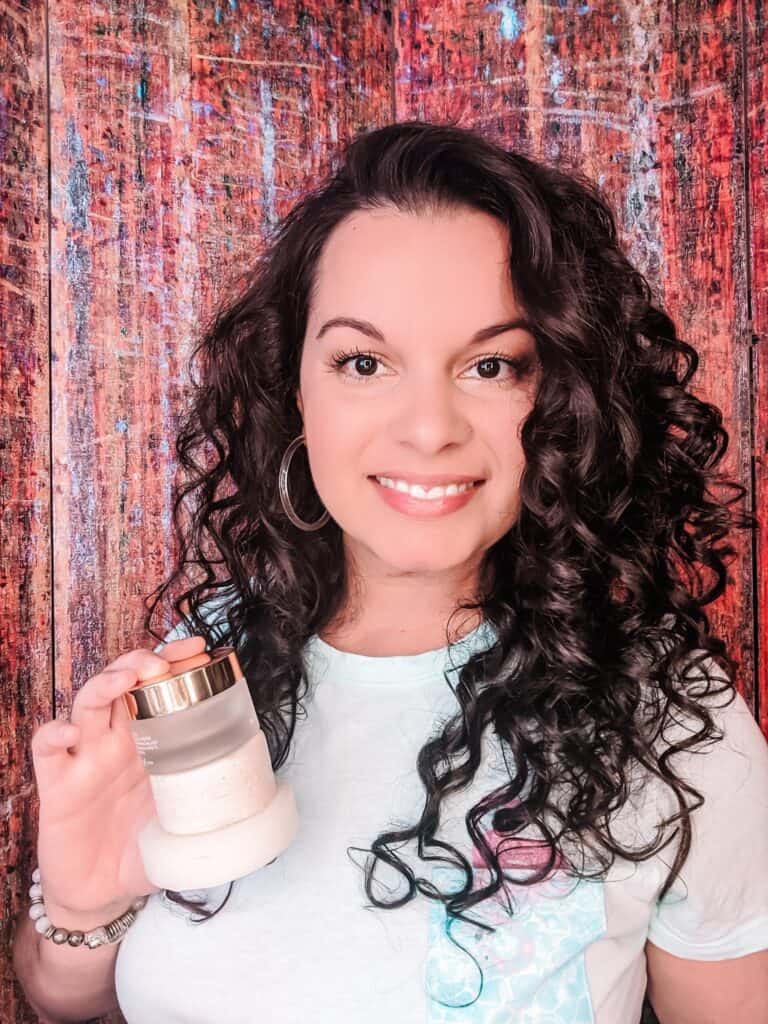 holding up zero waste curly hair products that I used to style my curly hair