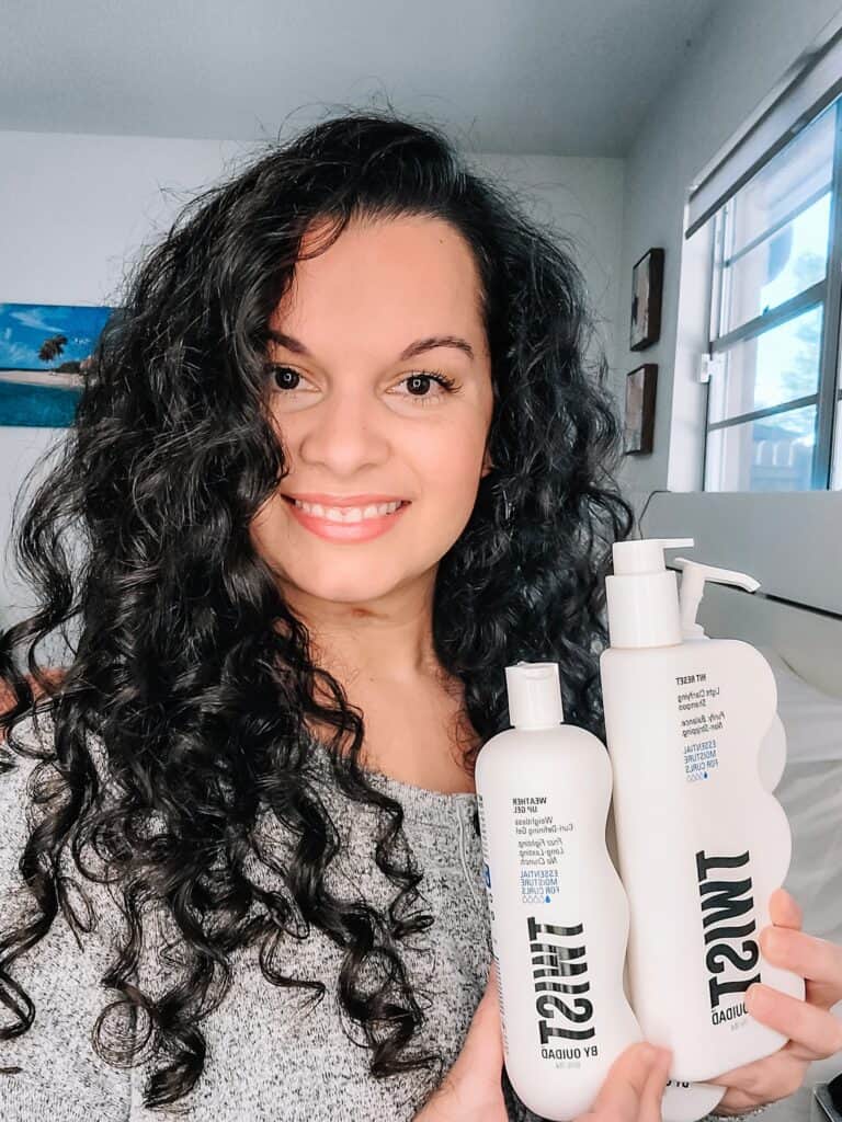 holding up anti-humidity hair products after styling curly hair