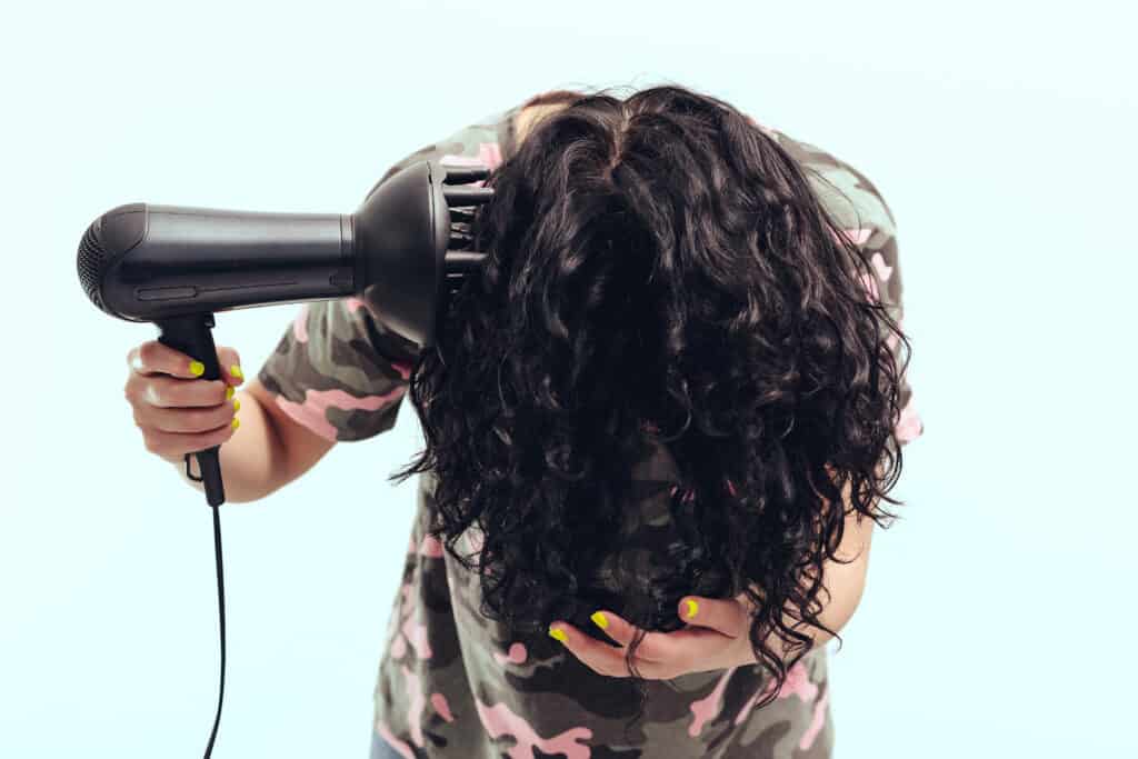 woman hover diffusing curly hair