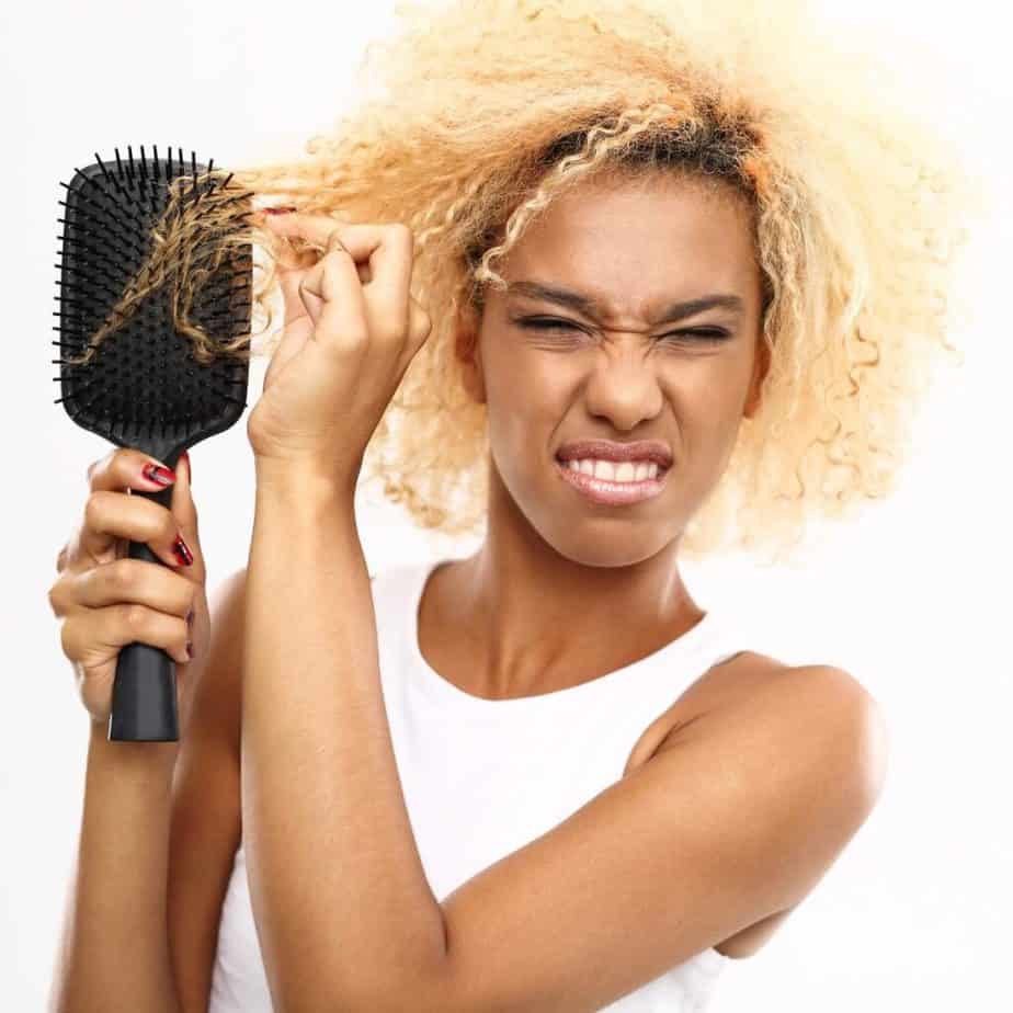 woman with matted hair stuck in a brush