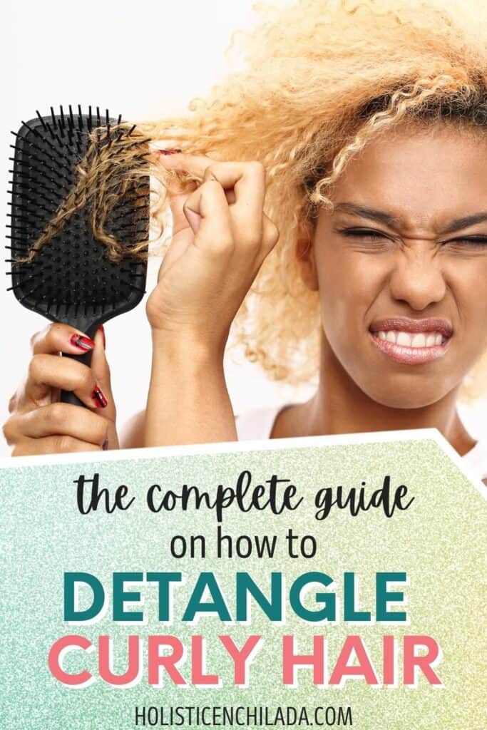 the complete guide on how to detangle curly hair text overlay on woman holding brush up tangled with her curly hair