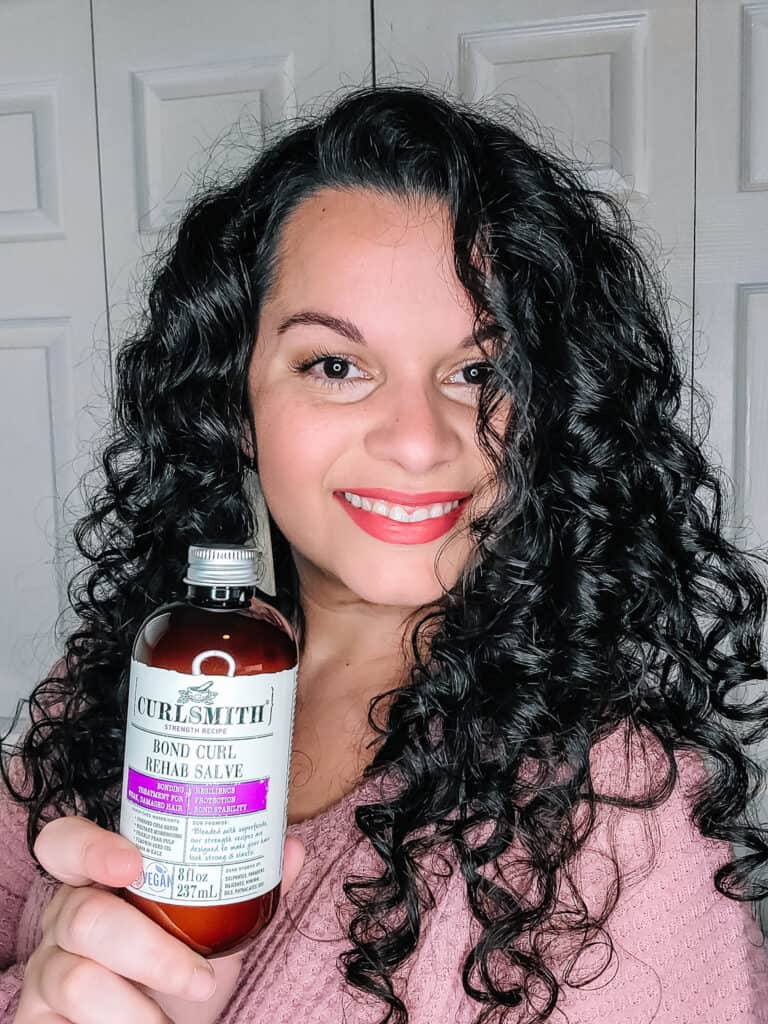 holding up a protein treatment for curly hair