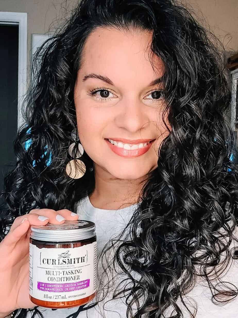 holding up Curlsmith Multi-tasking conditioner a coconut free deep conditioner