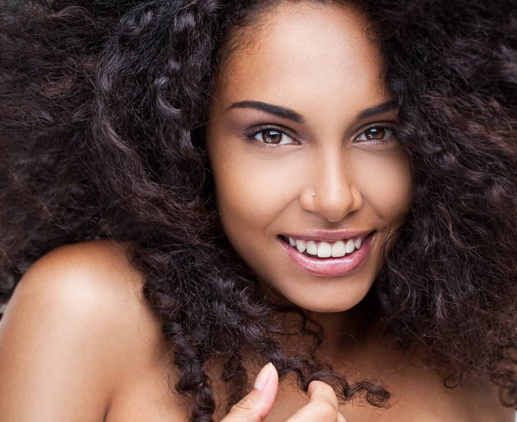woman with fluffy curly hair smiling