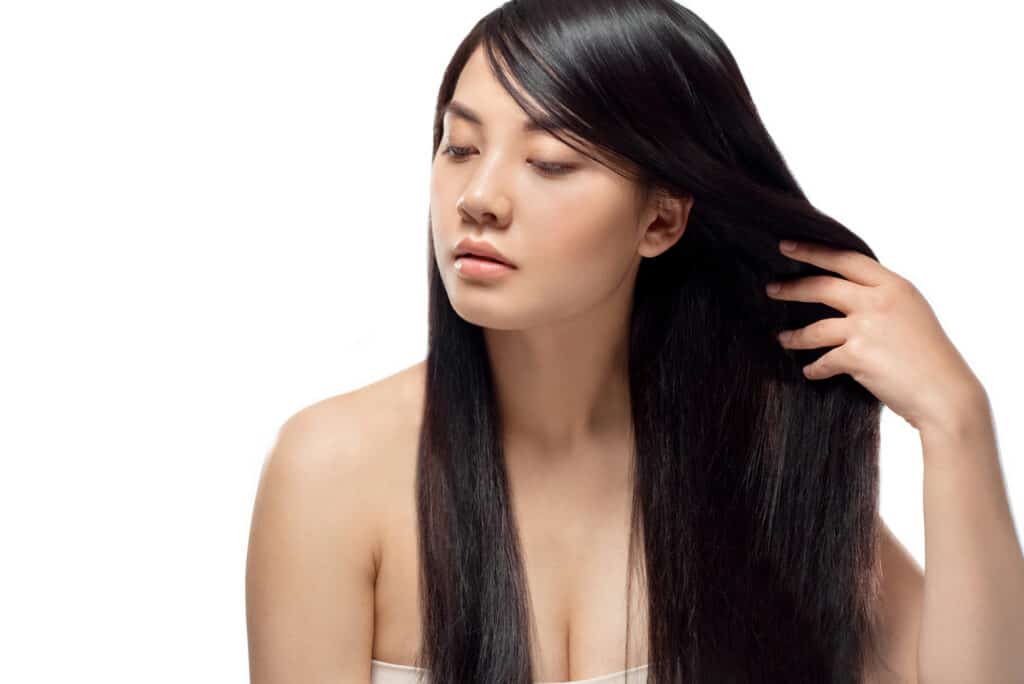 Asian woman with long brown straight coarse hair 