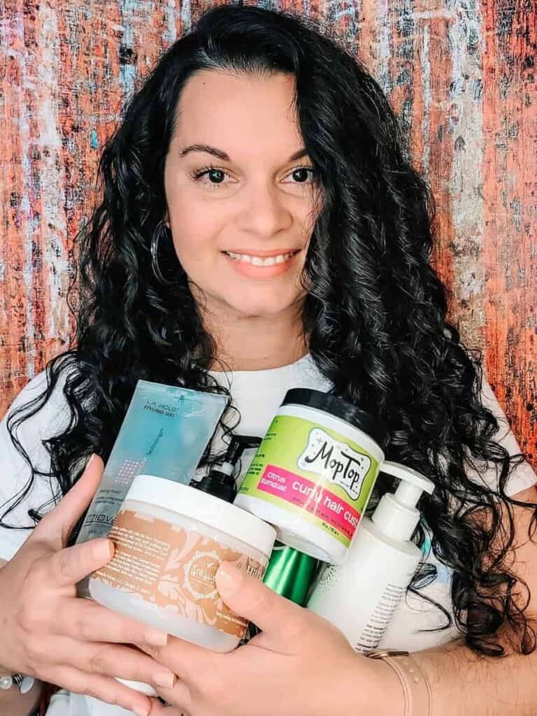 selfie holding up products to get defined curls