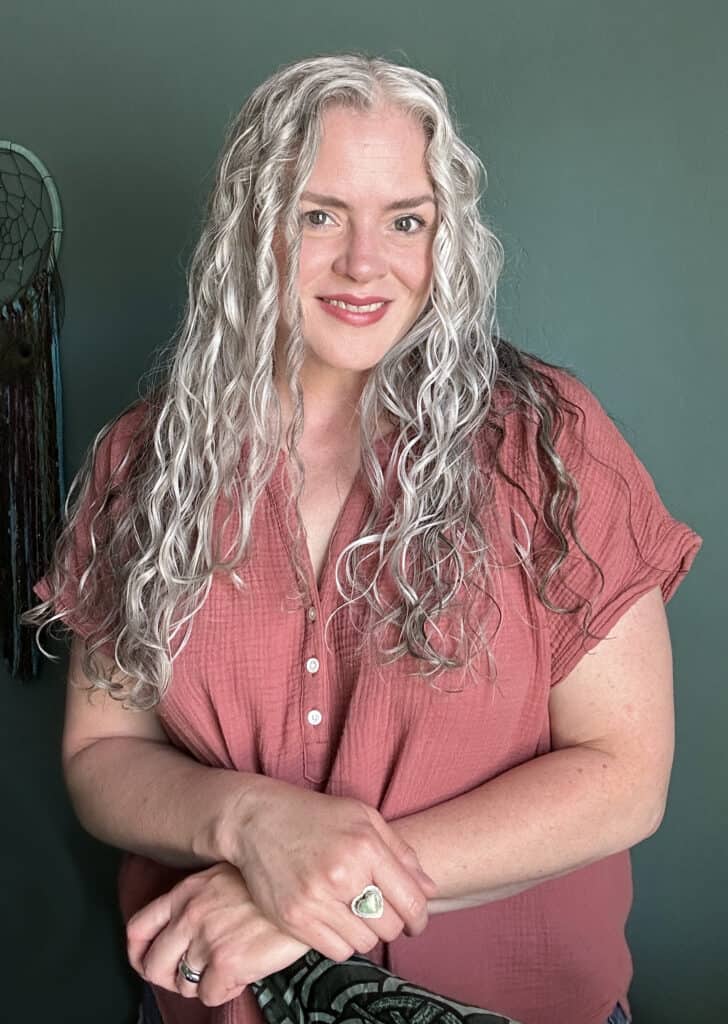 picture of Joli Capmbell of QuickSilverHair smiling with her long gray wavy hair