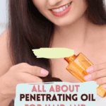 woman with long, dark hair smiling and pouring a small amount of oil into her other hand