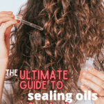 the ultimate guide to sealing oils for hair text overlay on woman with long curly hair applying oil to hair