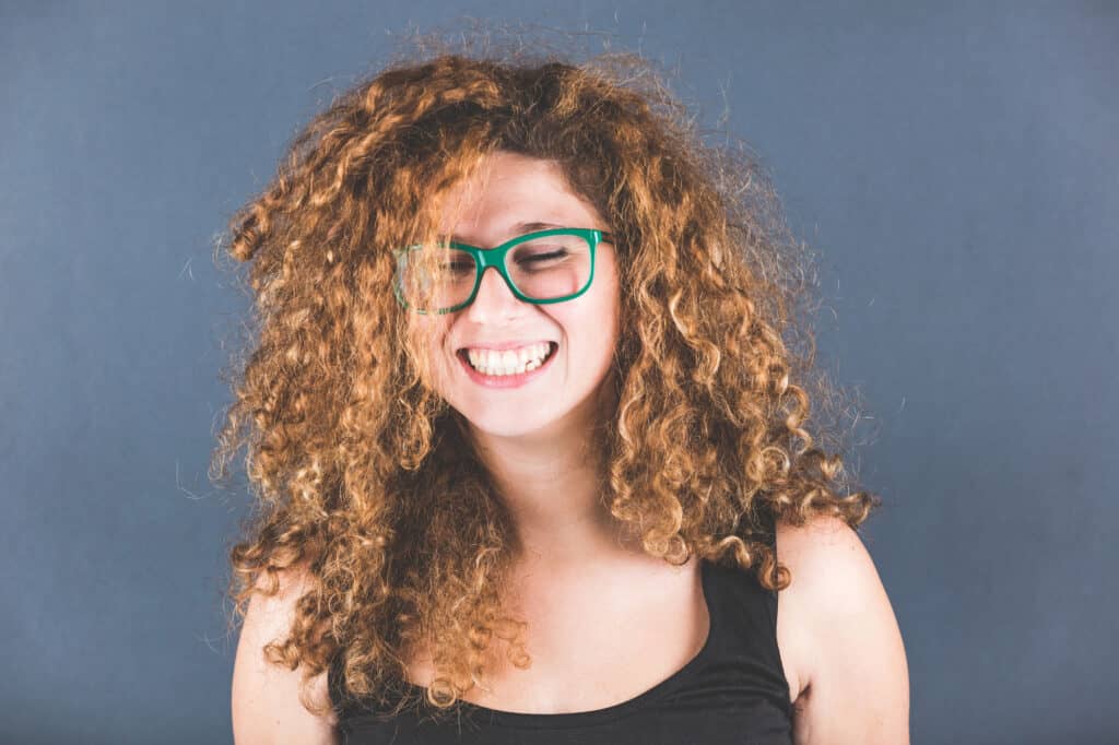 woman with curly hair with webbing and frizz