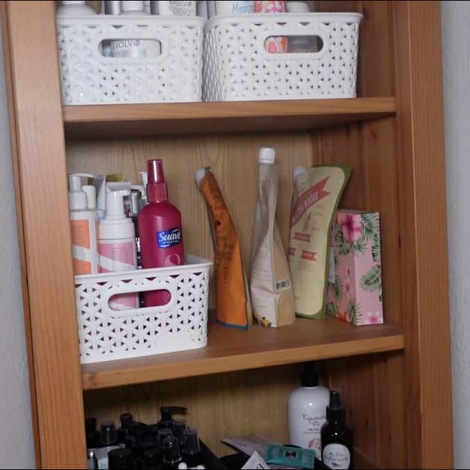 organized curly hair products on shelves after decluttering